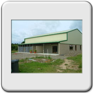 This picture showing the front of the kennels was taken when things were nearing completion. Missing are the PVC windows upstairs, fencing enclosing the patio area and the landscaping.