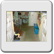 The entrance to the kennels; the three doors go into the different kennel sections with the fourth section entered under the stairs. Everything including the fridge is off the floor to ensure that total cleaning is possible. Dog food is held in the trolle